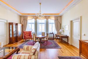 a living room with a table and chairs at Grandhotel Zvon in České Budějovice