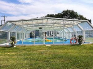 a glass greenhouse with a swimming pool in it at 2 bed in Aberaeron 75210 in Mydroilin