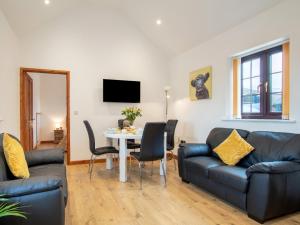 a living room with a couch and a table at 2 bed in Bath 72836 in Chew Magna