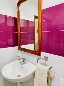 bagno con lavandino e specchio di Nouadhibou Guest House a Nouadhibou