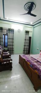a bedroom with a bed and a ceiling at Guru Kripa Guest House ( Home Stay ) in Ayodhya