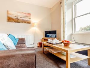 a living room with a couch and a table at 3 Bed in Edinburgh 79550 in Kirknewton