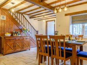 a dining room with a wooden table and chairs at 4 Bed in Brassington 85450 in Brassington
