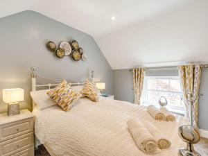 a bedroom with a large bed and a window at 3 bed in Bedale 88242 in Well