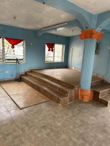 a room with a stage with blue walls and stairs at STONE CASTLE HOTEL in Freetown