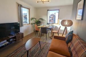 a living room with a couch and a table at Stunning Modern Coventry City Centre Apartment in Coventry