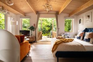 a bedroom with a bed and a wooden ceiling at Copperbeech - Luxury Holiday with Private Hottub in Blandford Forum