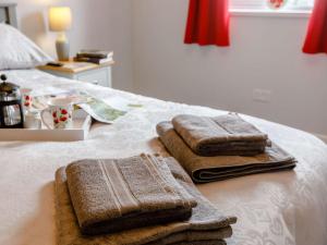 two towels are sitting on top of a bed at 1 bed in Cinderford 88271 in Cinderford