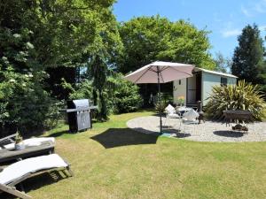 a backyard with a table and an umbrella at 1 bed property in Benenden BT096 in Benenden