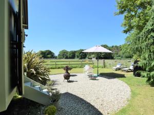 a patio with an umbrella and a table and chairs at 1 bed property in Benenden BT096 in Benenden