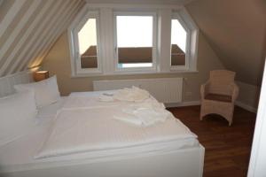 ヴィーク・アウフ・フェールにあるFiete Deppe Hausの窓付きの客室の白いベッド1台