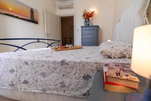 a bedroom with a bed and a table with books at VILLA INFINITY - Regarda Travel in Bardolino