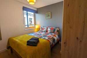 a small bedroom with a bed and a window at Stunning Modern Coventry City Centre Apartment in Coventry