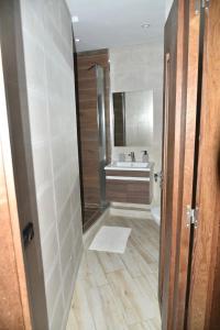 a bathroom with a shower and a sink at Stylish 3-Bedroom Flat in Kenitra Center Ville with Parking & Comfort in Kenitra +27 photos
