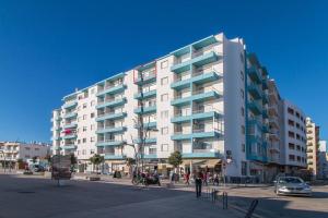 a large white apartment building in a city at Sea Side Apartment by SIDE VILLAS in Armação de Pêra