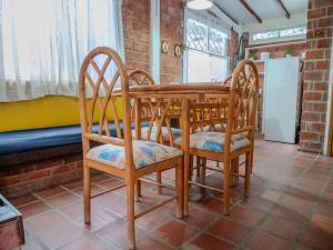a dining room table and chairs in a room at Las villas de Yoly in Playas