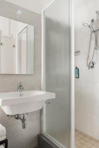a bathroom with a sink and a shower at Hotel Roxy & Beach in Cesenatico