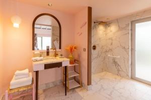 a bathroom with a sink and a shower at Tropical Hotel St Barth in Gustavia