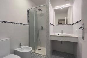 a bathroom with a toilet and a sink and a shower at Villa Federigo - Monte Argentario in Monte Argentario