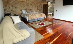 a bedroom with a bed and a wooden floor at leremita biohotel in Silvia