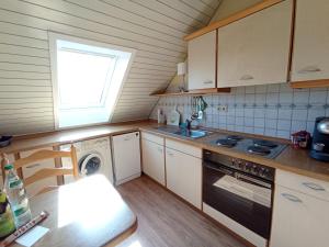 a small kitchen with a stove and a sink at Dachgeschoss - Maria von Berg - Wohnen auf Zeit in Rottweil