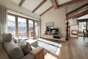 a living room with a couch and a tv at Alpine Lofts M26 in Grossarl