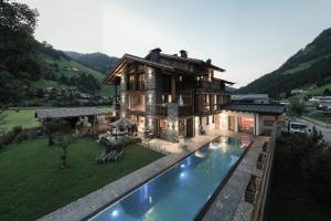 a house with a swimming pool in front of a house at Alpine Lofts M26 in Grossarl