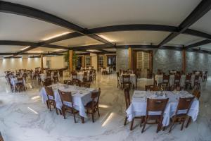 a banquet hall with white tables and chairs at Resort Fazenda 3 Pinheiros in Engenheiro Passos