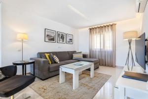 a living room with a couch and a table at Garden Hill Relax & Old Town by OCvillas in Albufeira