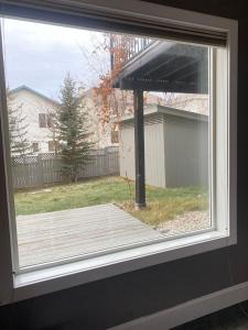 a window with a view of a wooden deck at lovely home in Calgary