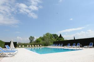 a swimming pool with lounge chairs and a swimming pool at Cà Donzella in Lazise