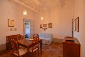 a living room with a table and chairs and a couch at Apartment Il Duomo in Poggio Mirteto