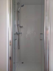 a bathroom with a shower with a glass door at Julija Mobile Lux in Vodice +29 photos