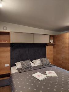 a bedroom with a bed with two towels on it at Julija Mobile Lux in Vodice