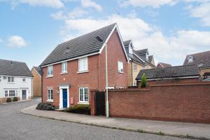 a red brick house with a black roof at Partridge Close in Stowmarket