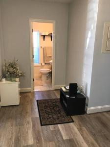 a room with a bathroom with a toilet and a rug at CLARENDON,SUPRLOCATION,8ppl,PRIVATE,METRO,PARK in Arlington +74 photos