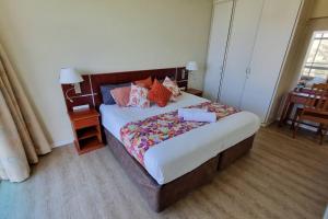 a bedroom with a large bed with pillows on it at Upmarket Beach Flat, Free WiFi & DisneyPlus in Durban