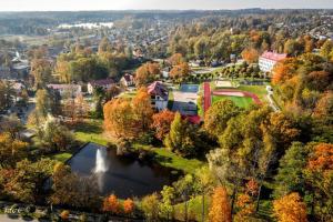 an aerial view of a park with a lake at Fukša Saules dzīvoklis in Madona