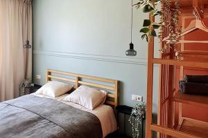 a bed with two pillows in a bedroom at Fukša Saules dzīvoklis in Madona