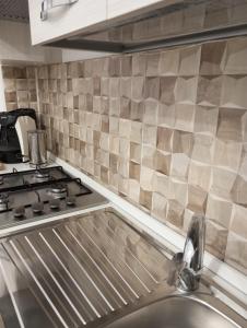 a kitchen with a stove and a sink at Casa Chiaretta in Palermo