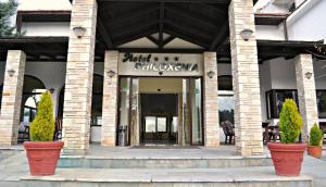 a store front with plants inront of a building at Philoxenia in Kavála
