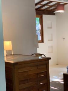 a wooden desk in a room with a chair at Casa sauá Trancoso in Porto Seguro +68 photos