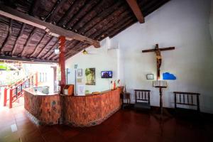 an altar in a church with a cross on the wall at Hotel La Casona Mompox in Mompós +19 photos
