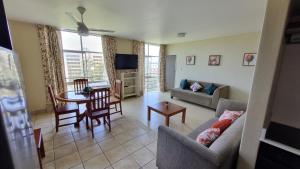 a living room with a couch and a table at Upmarket Beach Flat, Free WiFi & DisneyPlus in Durban
