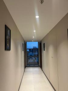 an empty hallway with a window in a building at Hotel Krystal in Sāngli