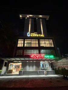a building with a neon sign in front of it at Hotel Krystal in Sāngli