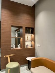 a room with a chair and a table and some vases at Hotel Krystal in Sāngli