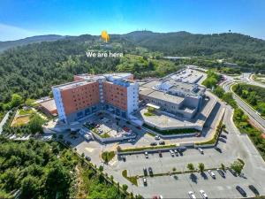 an overhead view of a building with a sign that says we are here at Philoxenia in Kavála