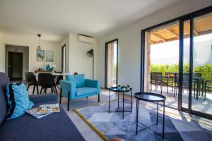 a living room with a couch and chairs and a table at Villa MAYA in Lecci
