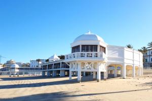 a large white building on the beach at Aire del Sur Cádiz in Cádiz